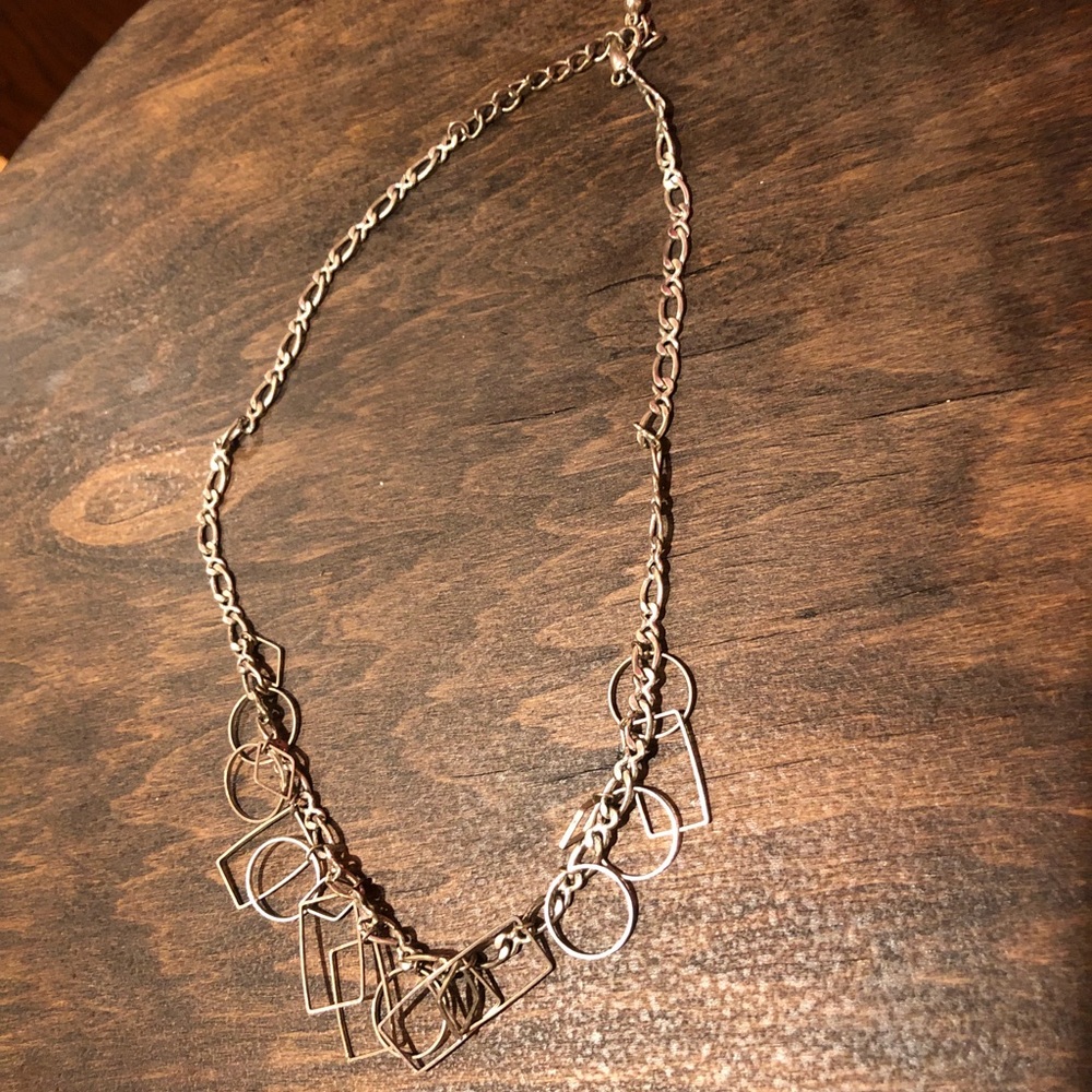 Silver chain link necklace with hanging shapes